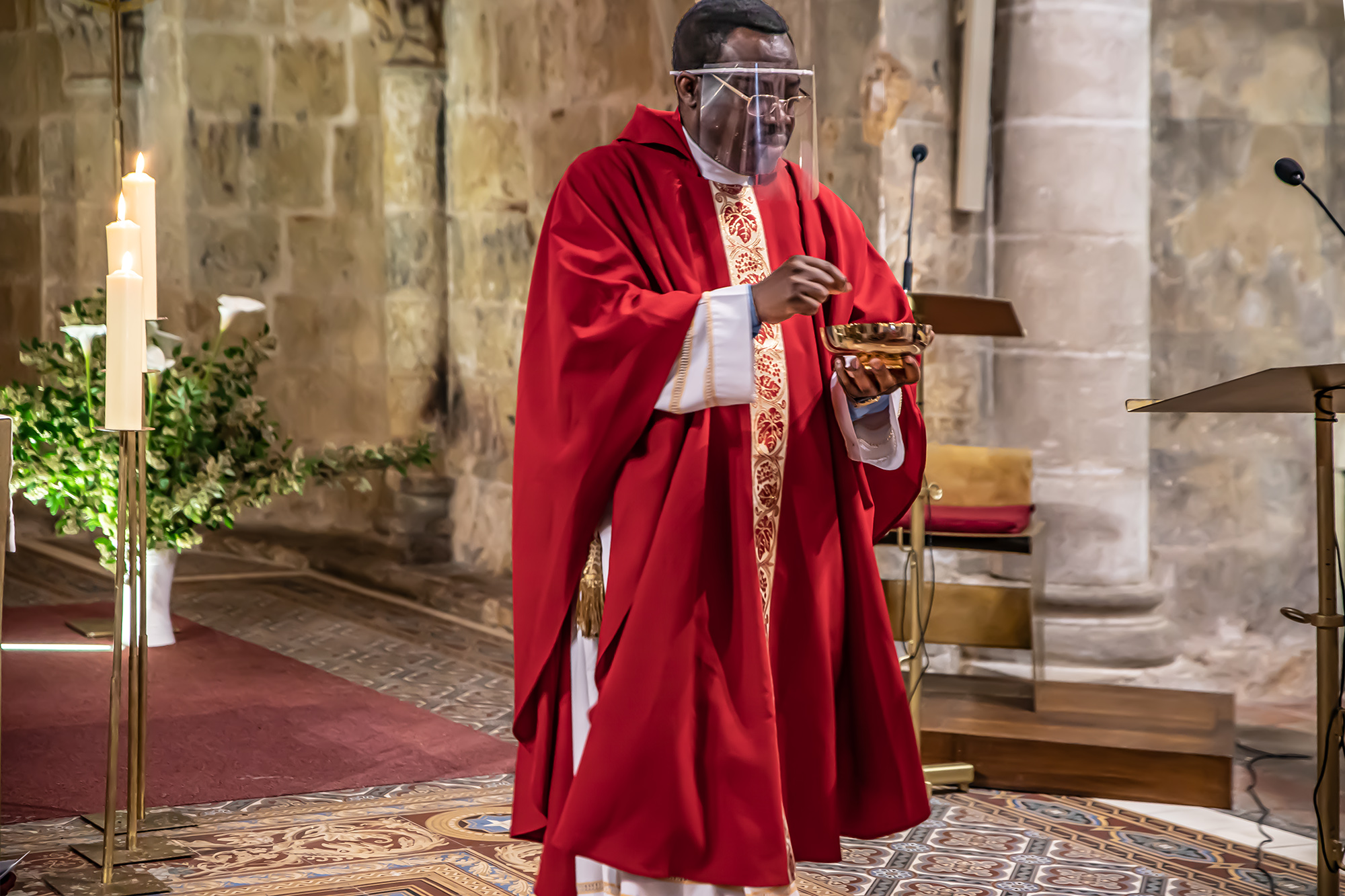 1  va donner la communion avec une visière 1bis 310520L'abbé Alexis Bankolé.jpg